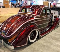 an antique car is on display in a showroom