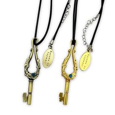 three different styles of key necklaces with names on them