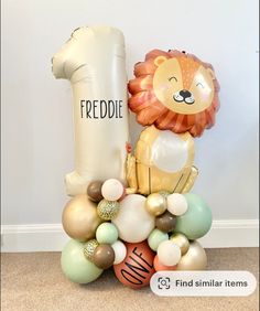 a lion balloon sitting on top of a pile of balloons