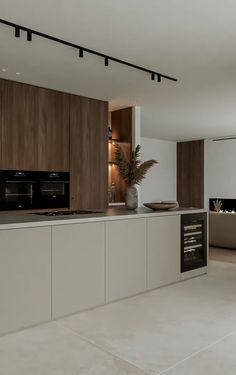 a modern kitchen with white and brown cabinets