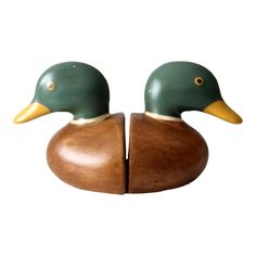 two wooden ducks sitting on top of each other