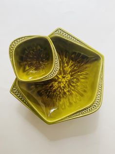 two yellow dishes sitting on top of each other