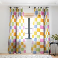 a room with a window and colorful curtains