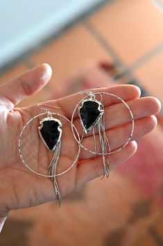 These are the most beautiful & elegant black Obsidian arrowhead earrings. Wear these from day to night and watch all the compliments come your way! Obsidian is a gorgeous black stone that comes from the magma that erupted from a volcano. Beauty can come from destruction. No matter what happens in life, these are your daily reminders to be rooted in love in all you do. Pair this with our Rooted in Love Obsidian necklace. Obsidian gemstone arrowhead pendants electroplated in silver 2" silver hoops Black Bohemian Pierced Jewelry, Unique Black Teardrop Jewelry, Bohemian Obsidian Jewelry For Healing, Bohemian Obsidian Jewelry With Natural Stones, Obsidian Necklace And Earring, Black Natural Stones Drop Earrings, Handmade Black Arrowhead Jewelry, Black Natural Stone Dangle Earrings, Unique Black Obsidian Jewelry