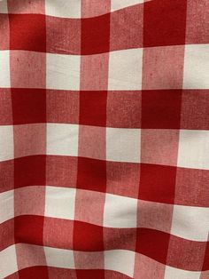 a red and white checkered fabric is shown in close up view with no image to describe