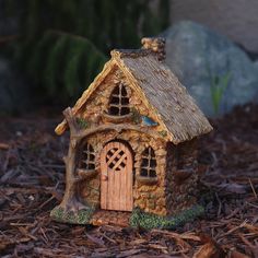 a small house made out of wood and grass