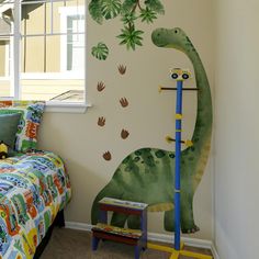 a child's bedroom with a dinosaur painted on the wall