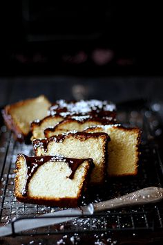 several pieces of cake sitting on a cooling rack