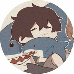 a boy laying in bed next to a dolphin with his head resting on the pillow