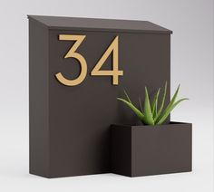 a black box with a plant in it and the number 34 written on its side