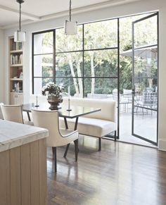 an open kitchen and living room with sliding glass doors