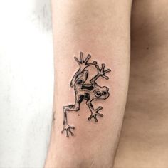 a frog tattoo on the right arm