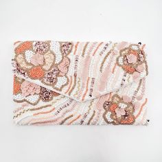 Experience the delicate colors of spring with our Shades of Peach Beaded Clutch. This beautiful beaded clutch is a perfect accessory for any women's wardrobe, reflecting the rich, craftsmanship of South America. Lined Front Magnetic Closure Dimensions: 10" wide, 6.5" tall 50" Long Goldtone Chain Strap 100% Cotton Spot Clean Only Made in Colombia Pale White Skin, Fancy Purses, Shades Of Peach, Beaded Clutch, Embroidered Bag, Women's Wardrobe, Chain Strap, Online Boutique, Bag Making