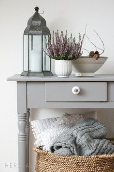 a white table with a basket on top of it