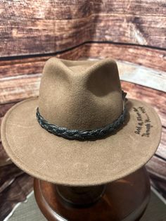 quote reads: Eventually, all things merge into one and a river runs through it Norman Maclean Braided Fedora With Curved Brim For Rodeo, Curved Brim Braided Fedora For Rodeo, Casual Brown Braided Fedora, Brown Braided Fedora Straw Hat, Brown Braided Brimmed Panama Hat, Western Style Fedora With Short Brim And Braided Detail, Brown Fedora With Braided Curved Brim, Brown Fedora With Braided Detail And Curved Brim, Brown Braided Panama Hat With Short Brim