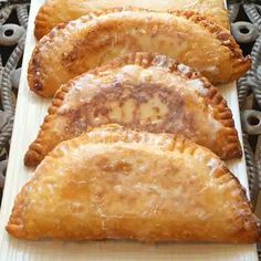 three pastries sitting on top of a white plate