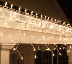 white lights are strung on the outside of a house