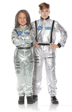 two children in silver space suits standing next to each other with their hands on their hipss