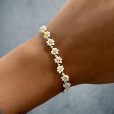 Daisy cabin flower bracelet with silver lobster clasp Flower Shaped Bracelets For Beach, Adjustable White Bracelet With Flower Decoration, Flower Friendship Bracelets For Beach, Summer Flower Beaded Bracelets, Trendy Beaded Bracelets With Lobster Clasp, Trendy Silver Flower Bracelets, Casual Flower Bracelets For Beach, Adjustable Flower Bracelets With Lobster Clasp, Trendy White Bracelets With Lobster Clasp