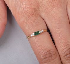 Emeralds are often associated with love and fidelity. Wearing this gemstone is believed to strengthen existing relationships, promoting loyalty and unity between partners. It can also attract new love into your life, as it radiates an energy of unconditional love and compassion. Gemstone: Lab Grown Emerald Shape/Size: Octagon 6x2.5MM  Finish Type: White rhodium/ yellow gold plating/rose gold plating / Solid14K Gold also available Ring Size: US Ring sizes 3-12  Metal Type: 925 Sterling Silver / S 14k Gold Emerald Cut Birthstone Promise Ring, 14k Gold Emerald Cut Promise Ring, Dainty Emerald Cut Rings For Anniversary, Dainty Emerald Cut Birthstone Ring For Anniversary, Elegant Stackable Rings With May Birthstone For Anniversary, Fine Jewelry Three Stone Stackable Rings For Anniversary, Elegant Stackable Rings For Anniversary With May Birthstone, 14k Gold Birthstone Ring For Anniversary, Emerald Cut, 14k Gold Three-stone Emerald Ring As Gift