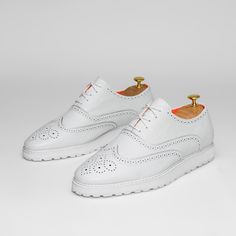 The Priority Leather White Low Top Leather Sneaker With Soft Foam Sole.. Made With Premium Soft Leather Upper. Made With Soft Mesh Lining And Removable Soft Insole For Comfort. Toe Shape Round Pattern Wingtip Closure Lace Up Width Wide Upper Mat Leather Upper Color White Lining Mat Mesh Lining Color Orange Insole Mat Foam Insole Color Orange Welt Mat Rubber Welt Color White Sole Mat Foam Sole Color White White Plain Toe Lace-up Shoes For Derby, White Lace-up Shoes With Brogue Detailing, White Leather Lace-up Shoes With Textured Sole, Classic White Leather Shoes For Summer, White Leather Shoes With Textured Sole For Spring, White Wingtip Lace-up Casual Shoes, Spring White Leather Shoes With Textured Sole, White Brogue Lace-up Shoes For Derby, White Flat Heel Dress Shoes For Business