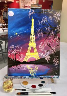 the eiffel tower is painted on an easel