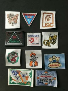 several different types of embroidered patches on a black surface