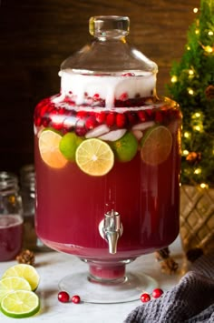 a drink dispenser with cranberry punch and limes