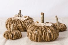 twine wrapped pumpkins sitting on top of a bed