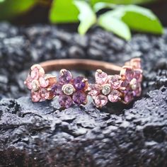 a close up of a ring with flowers on it