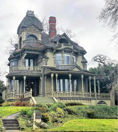 an old victorian style house on a cloudy day