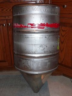 a large metal barrel sitting on top of a kitchen floor