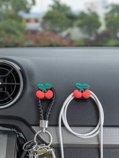 the interior of a car with two cell phone holders attached to the dash board and charging cable