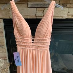 This Dress Has Beautiful Straps And Has Never Been Worn. It Is A Peach Color. Made For A Bigger Busted Person. Peach Sleeveless Prom Dress, Peach V-neck Evening Dress, Summer V-neck Homecoming Maxi Dress, Peach V-neck Maxi Dress For Parties, Summer V-neck Maxi Dress For Homecoming, V-neck Spring Homecoming Maxi Dress, Peach V-neck Dress For Party, Peach V-neck Maxi Dress For Wedding, Peach Homecoming Dresses