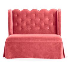 a red couch with a ruffled skirt on it's back and the seat upholstered