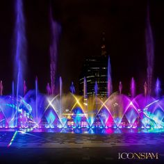 the colorful fountain show is lit up at night