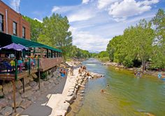 people are swimming and playing in the river