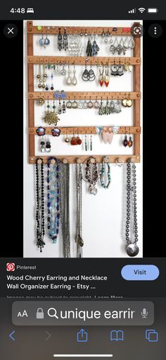 an iphone screenshot of jewelry hanging on a wall