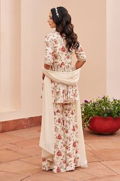 Ivory peplum kurta with floral print and bead, sequin, zari thread embroidered bodice. Paired with printed sharara and dupatta. - Aza Fashions Fitted Off White Palazzo Set With Dupatta, Traditional Off-white Floral Print Sets, White Sharara With Printed Motifs For Wedding, Wedding White Sharara With Printed Motifs, Festive Off White Sets With Floral Print, Festive Off White Floral Print Sets, Festive Off-white Floral Print Sets, Cream Cotton Sharara For Wedding, Fitted Off White Straight Kurta Set