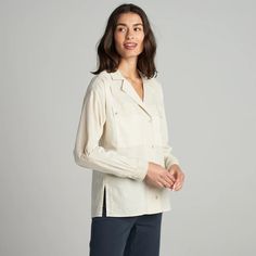 The Fay Utility Camp Shirt is roomy and relaxed but decidedly feminine and sophisticated. Crafted from cotton lawn, a lightweight yet durable fine thread poplin, the Faye has a silky-smooth hand feel. Its unique features include a lay-flat camp collar with an elevated top button and loop closure, wide-set center front Spring Johnny Collar Camp Shirt For Work, Johnny Collar Camp Shirt For Spring Workwear, Spring Workwear Camp Shirt With Johnny Collar, Daywear Blouse With Camp Collar, Relaxed Fit Camp Shirt With Spread Collar For Work, Cotton Camp Collar Blouse For Work, Cotton Blouse With Camp Collar For Work, Relaxed Fit Camp Collar Blouse For Work, Relaxed Fit Blouse With Pockets And Camp Collar