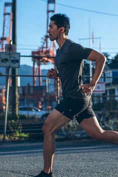 a man running down the street in shorts