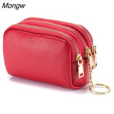 a red purse with gold zippers and a keychain hanging from the front