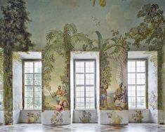 an artisticly painted room with four windows