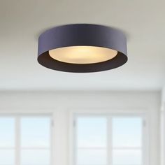 a modern ceiling light in an empty room