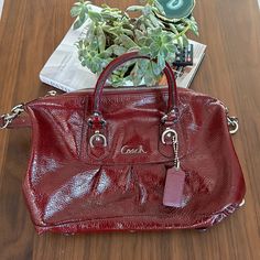 Material: Real Leather Color: Maroon Red Brand: Coach Condition: Like New Coach Red Satchel With Detachable Handle, Red Coach Satchel With Top Carry Handle, Coach Red Satchel For Daily Use, Coach Red Satchel With Adjustable Strap, Red Coach Satchel With Adjustable Strap, Coach Burgundy Bag With Zipper Closure, Red Purse, Red Purses, Bags Coach