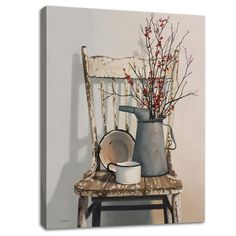 an old chair with a vase on it next to a white cup and saucer