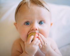 a baby chewing on a toy with the words branding conspensery in front of it