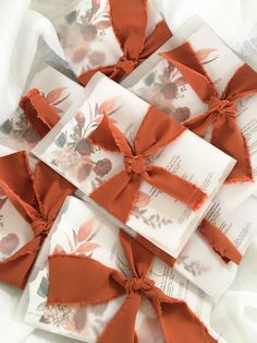 several pieces of ribbon tied together on top of paper with flowers and leaves printed on them