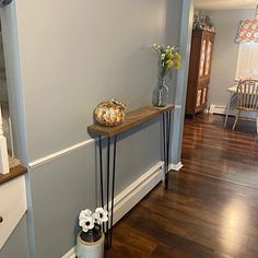 the hallway is clean and ready to be used as a place for flowers or candles