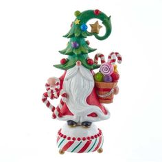 a glass ornament with a christmas tree and candy canes on it's top